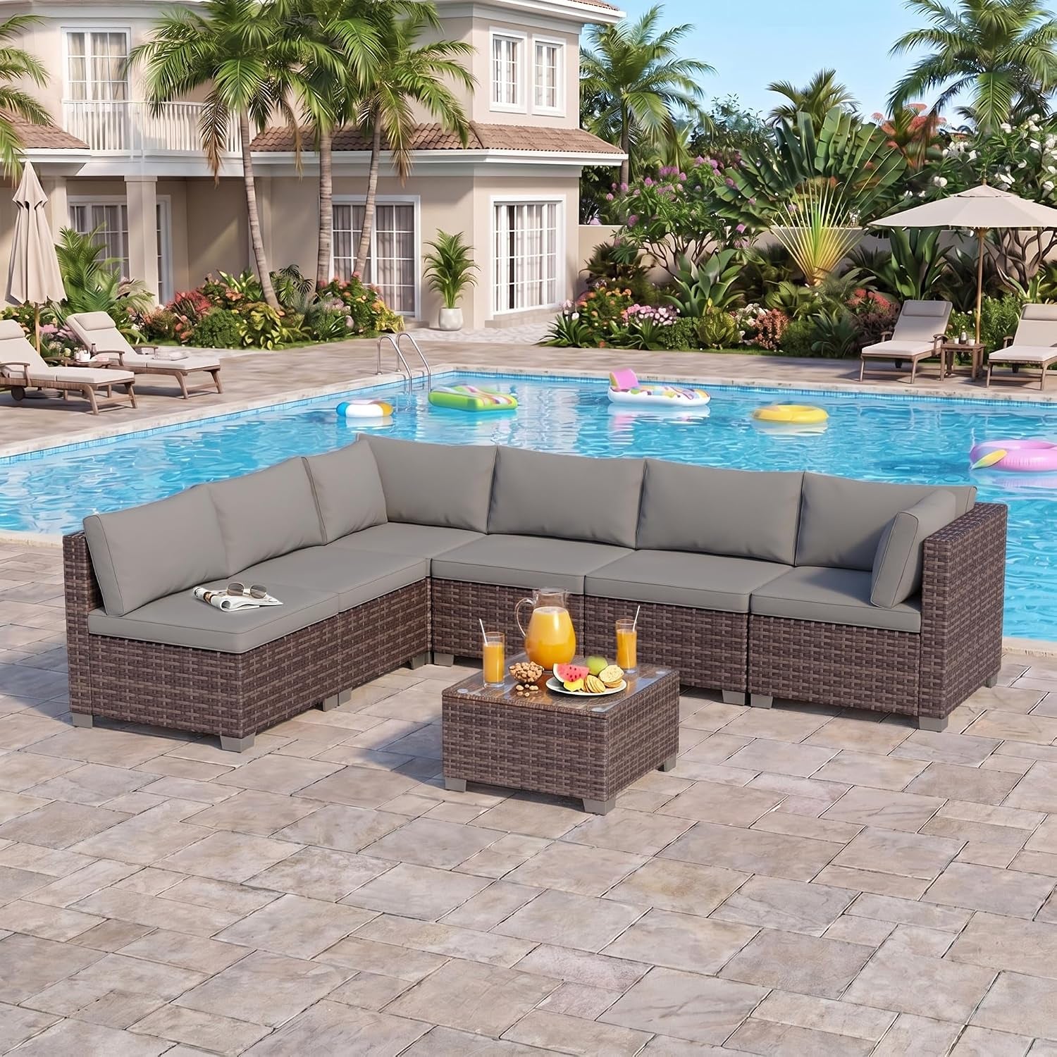 Outdoor patio view showing an L-shaped brown rattan sectional with gray cushions beside a swimming pool.
