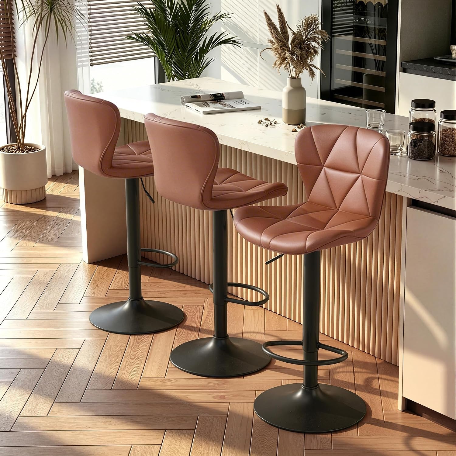 Three warm cognac-brown bar stools lined along a fluted wood-front counter in sunlight.