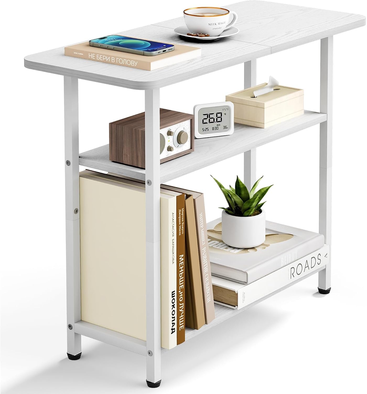 White three-tier side table shown with decor items and books arranged on its shelves against white backdrop.