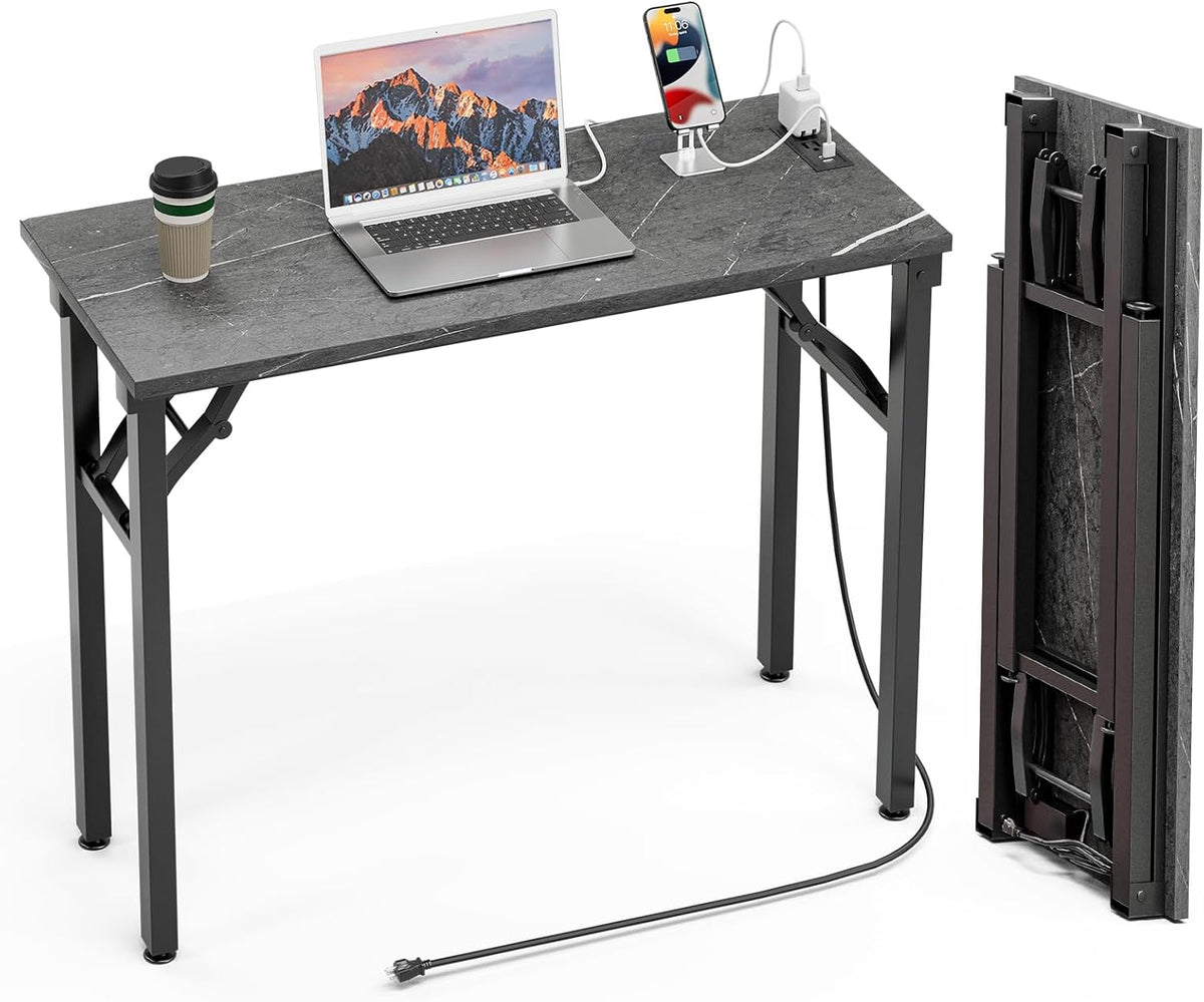 Front-facing shot of the desk showing black folding legs, a long power cord trailing to the floor and the tabletop stored