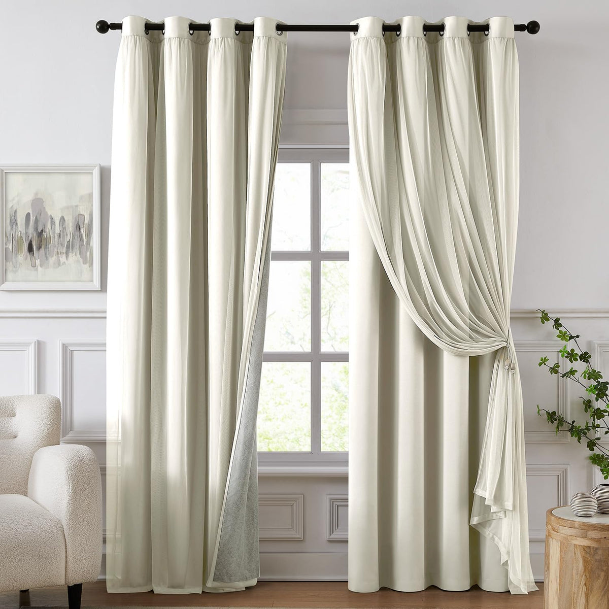 Full-length ivory blackout panels with sheer overlay pulled to one side over a paneled window