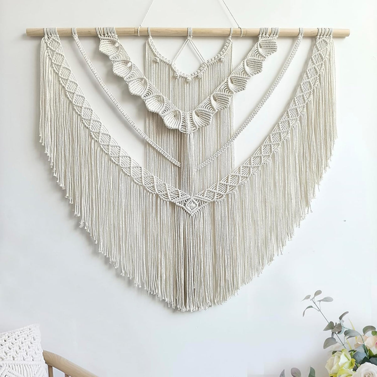 Straight-on view showing a V-shaped arrangement of braided panels and long hanging fringe.