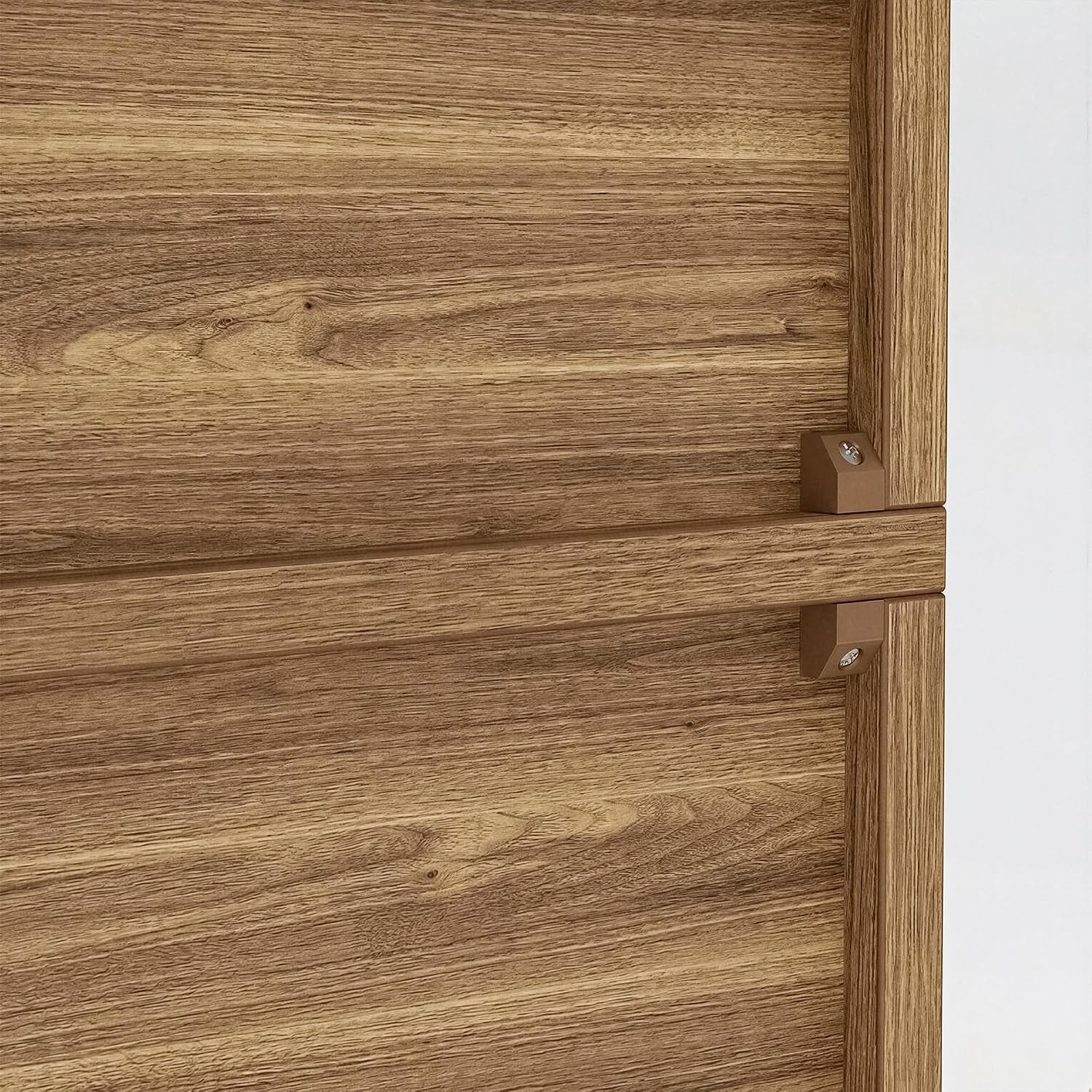 Close-up of wood-grain shelf edge and two small rectangular shelf support pegs on a light brown panel