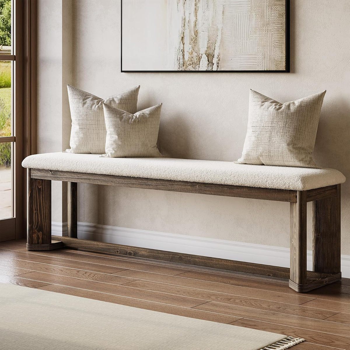 Long upholstered bench with white faux fur cushion and wood sled-style base, styled with neutral throw pillows