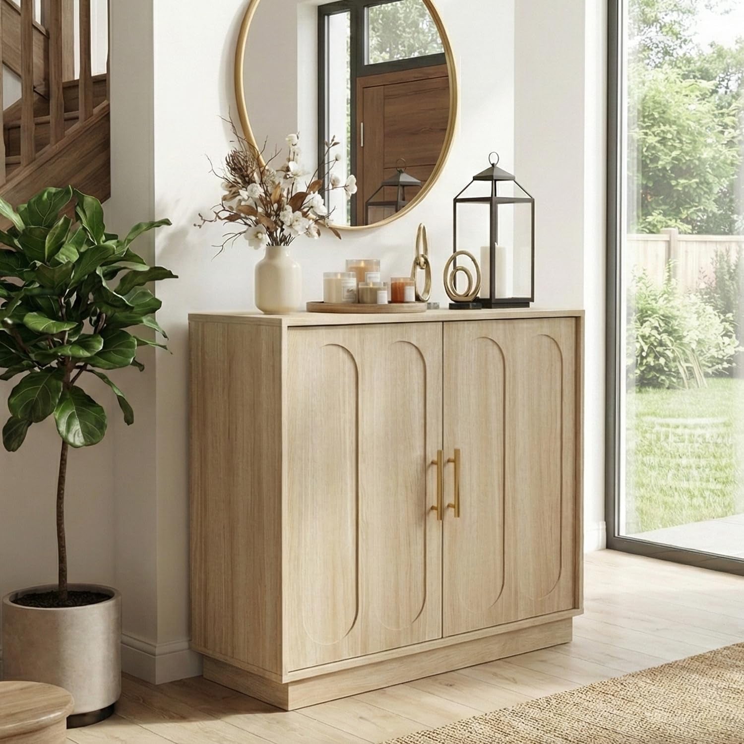 Light wood two‑door fluted storage cabinet beside a tall potted plant and round mirror