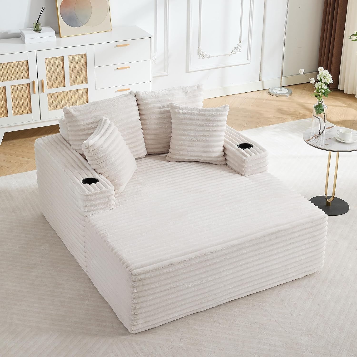 Off-white wide chaise shown from above with ribbed fabric and built-in arm cup holders.
