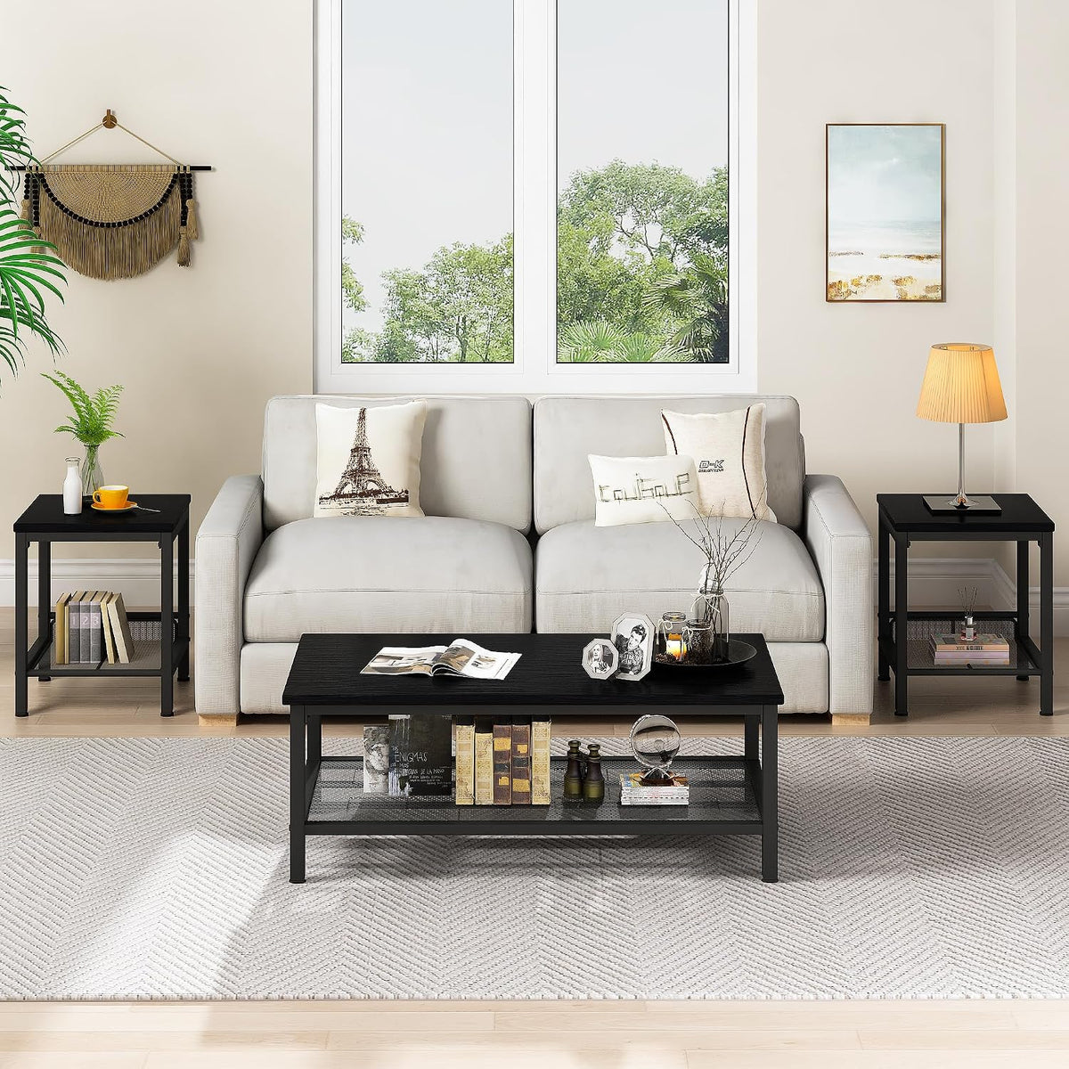 Front-facing living room view with a light sofa, decorative pillows, two black end tables and a black coffee table on a