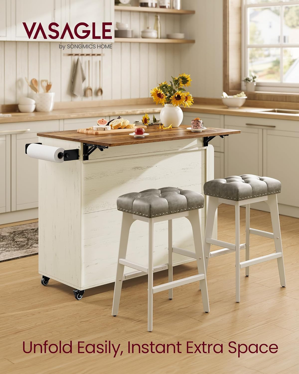 Rear view of the island with brown top and paper-towel holder, drop-leaf raised and two bar stools beside it
