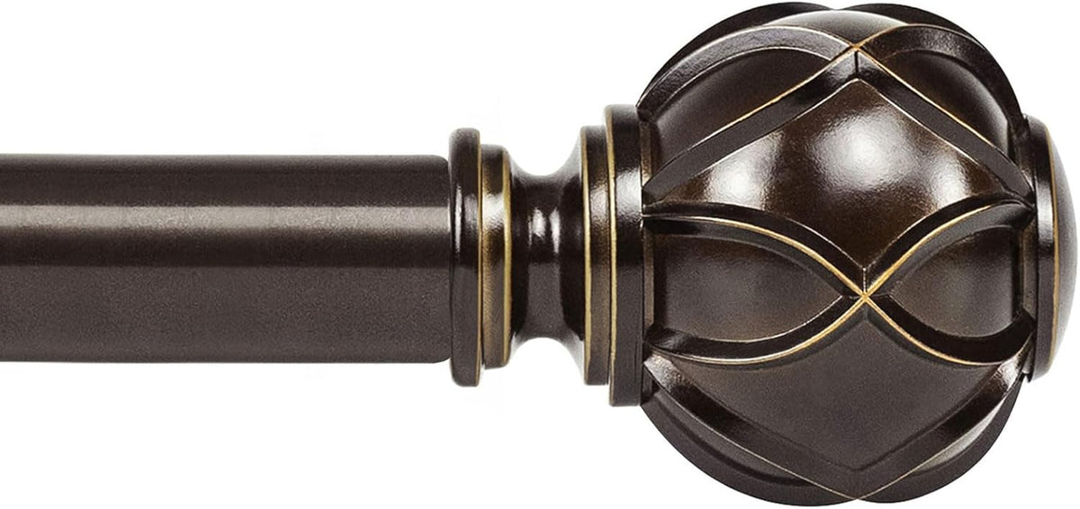 Close-up of a dark bronze curtain rod finial with carved petal-like geometric design and matching rod.