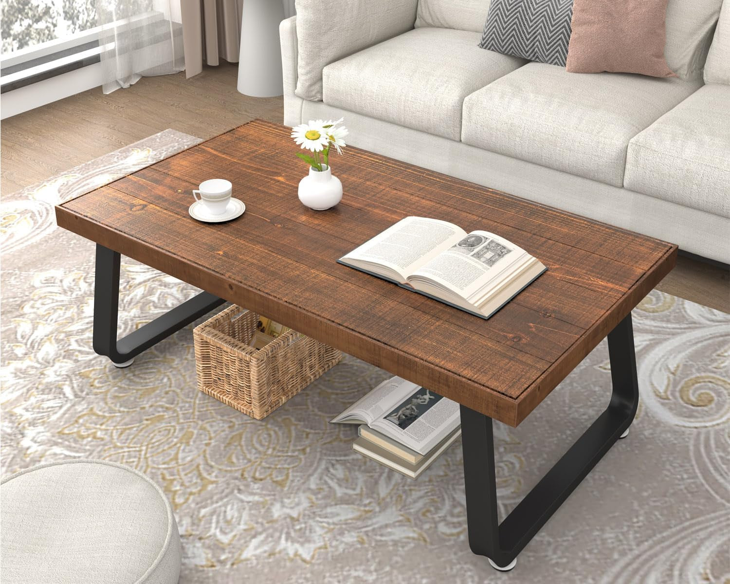 Angled top view of the rustic fir coffee table in a living room with a book, cup, and woven basket stored underneath