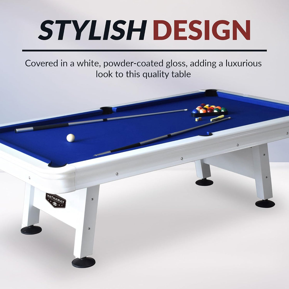 Angled view of a white pool table with bright blue felt, cues and racked balls on top