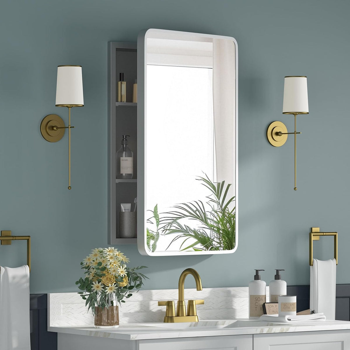 Rectangular mirrored medicine cabinet mounted above a sink with open side shelf and gold faucet in a teal bathroom