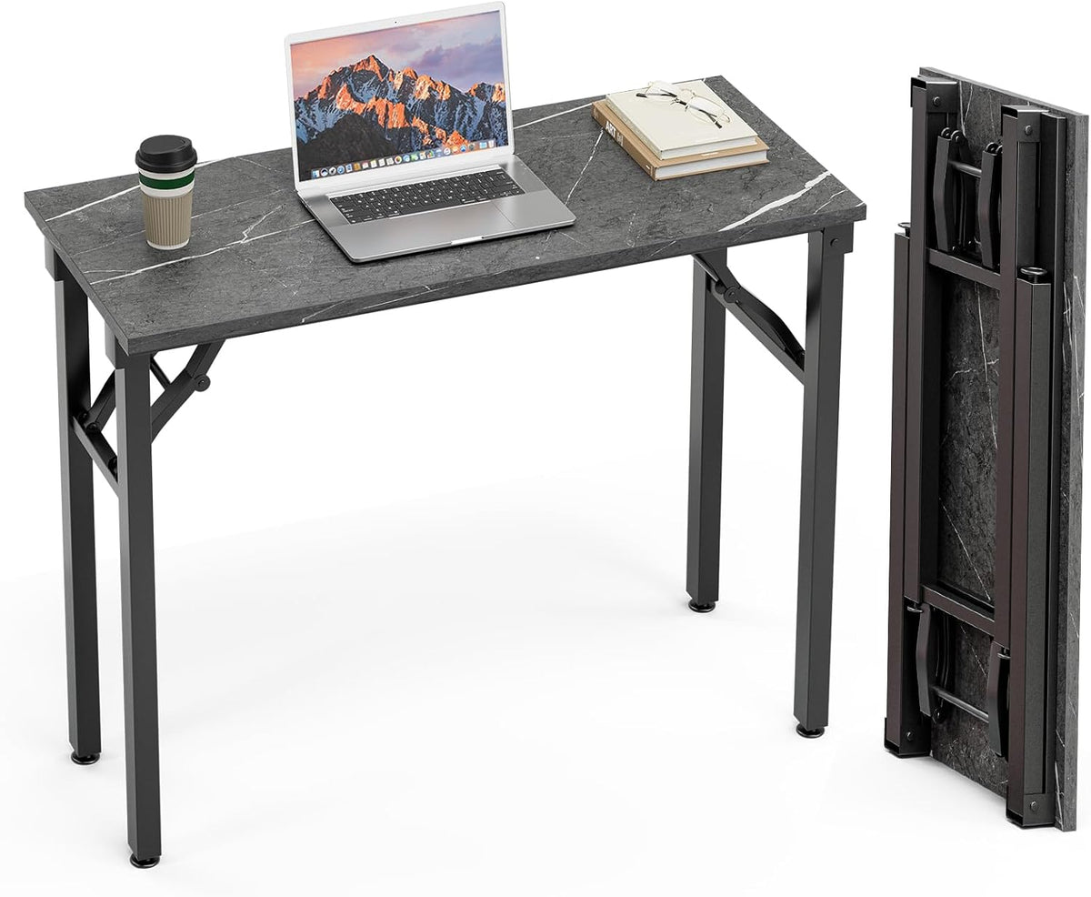 Dark gray marble-look tabletop with laptop and books, plus the matching folded panel standing upright to the right.
