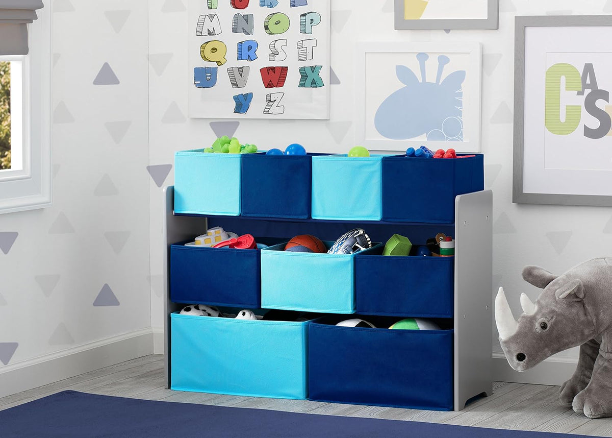Organizer placed in a child's room with toys visible in the blue bins and a large stuffed rhinoceros on the floor.