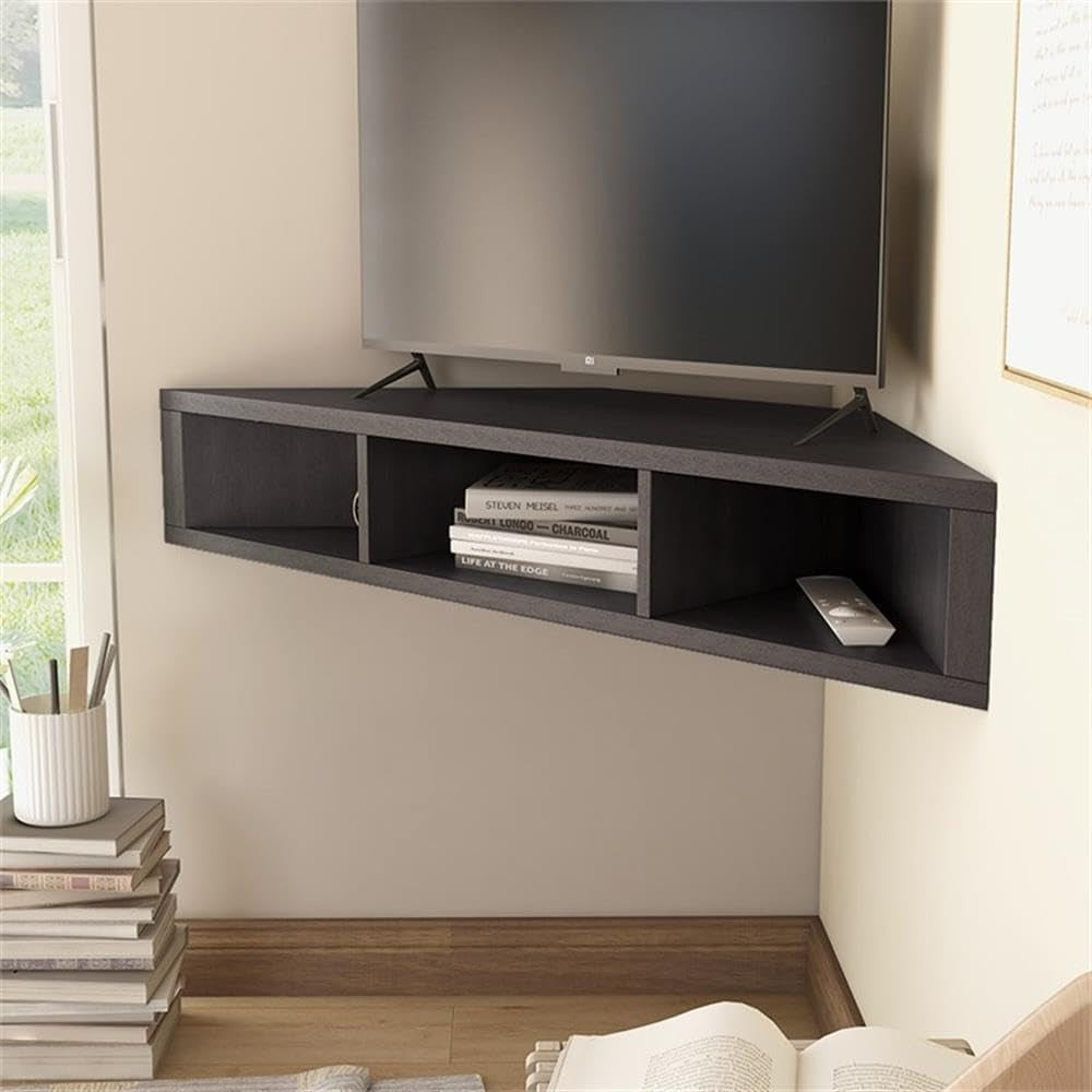 Angled close-up of cappuccino corner floating TV stand showing open compartments with a remote and stacked books