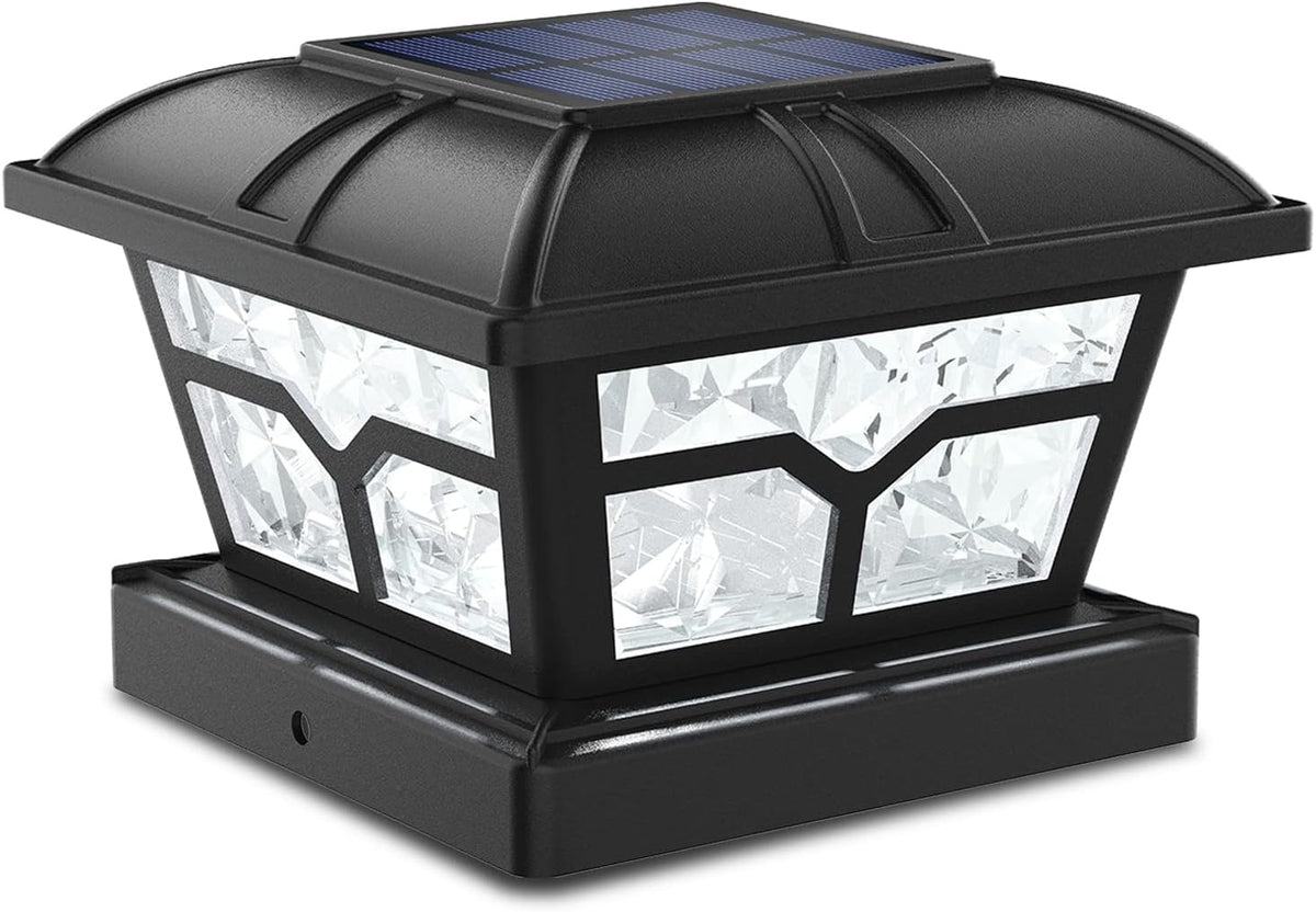 Black post cap light shown at an angle, with a solar panel and faceted clear sides.