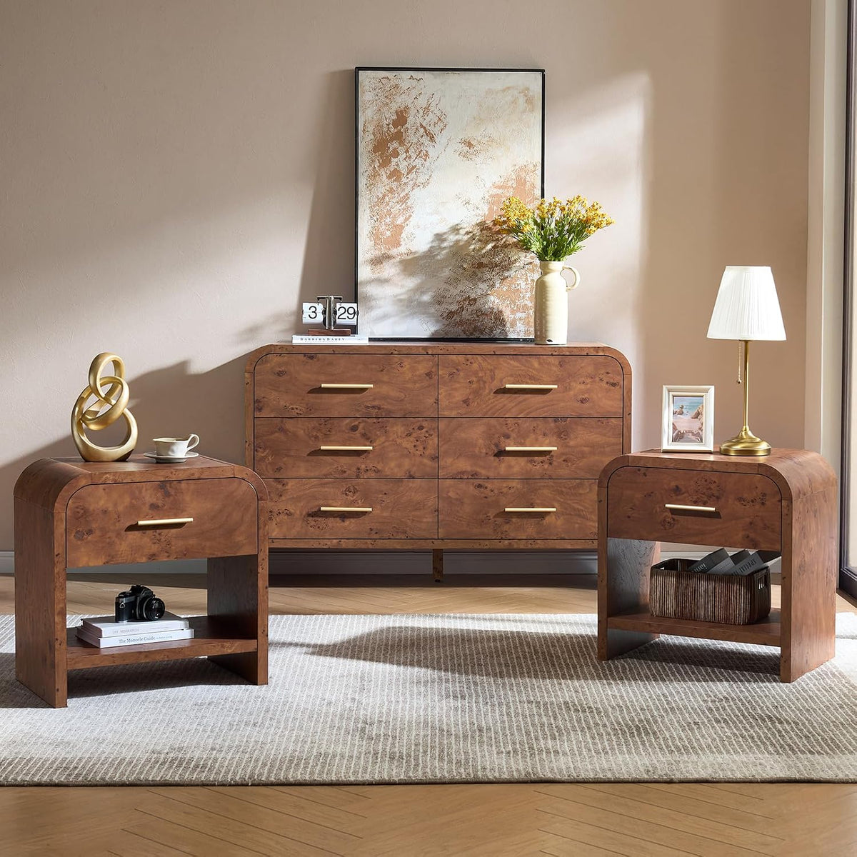 Angled view of brown nightstands with lower shelf holding a camera and books, dresser centered behind.