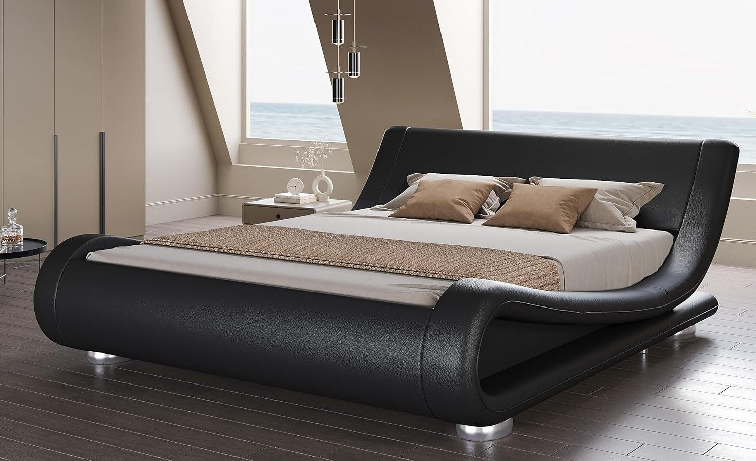 Low perspective of the black platform bed highlighting the curved frame and cylindrical silver feet