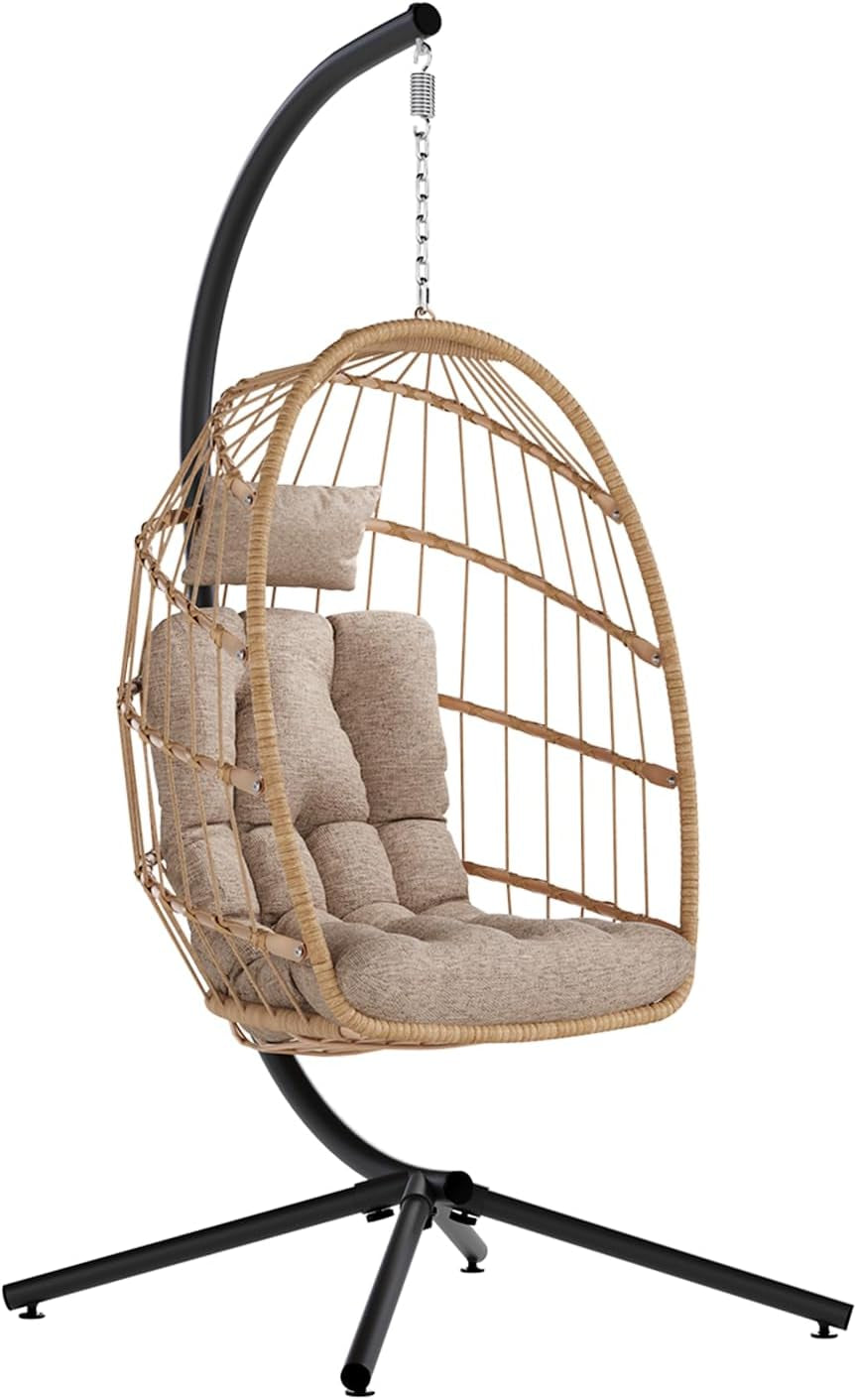 Tan woven egg chair on a black metal stand with tufted beige cushion and head pillow