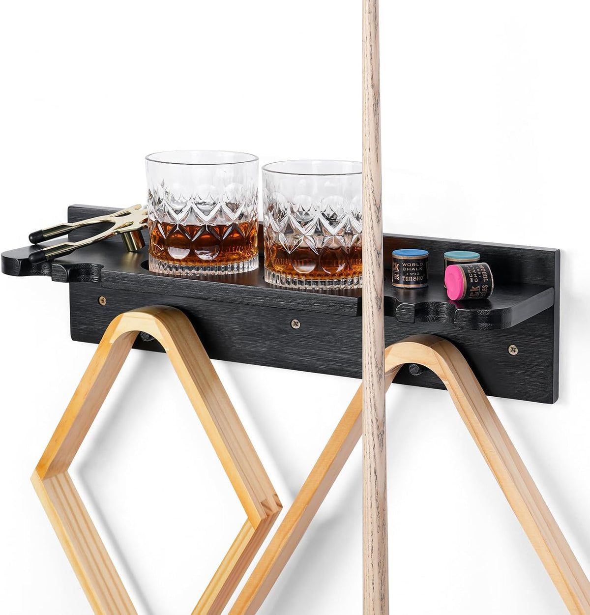 Close-up of a black wall-mounted cue shelf holding two glasses, chalk and a cue shaft in front.