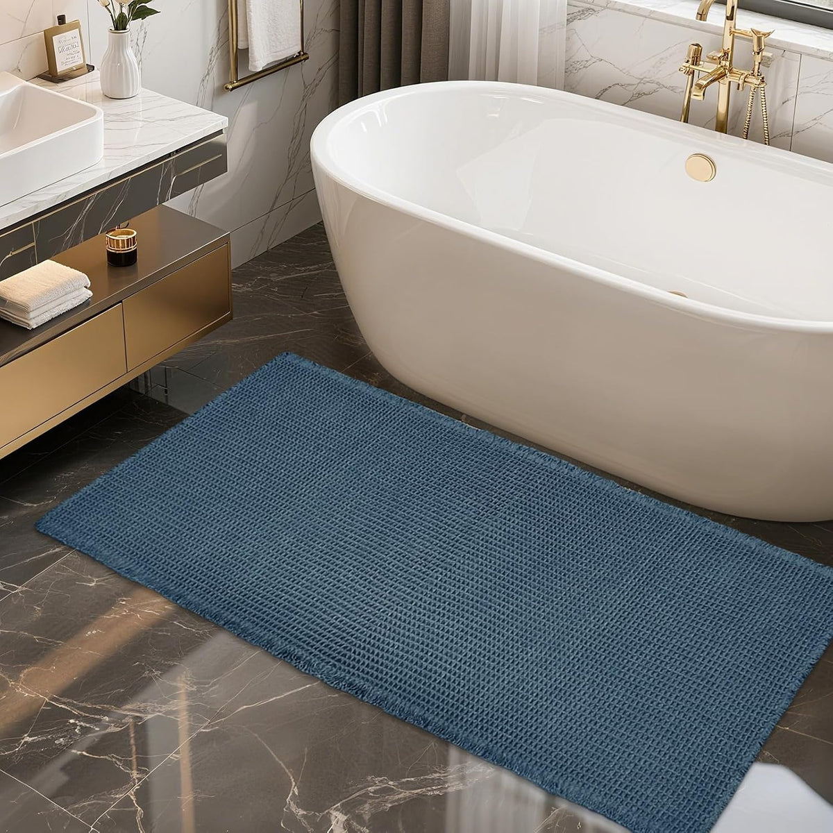 Deep blue waffle runner positioned in front of a white freestanding bathtub on polished tile