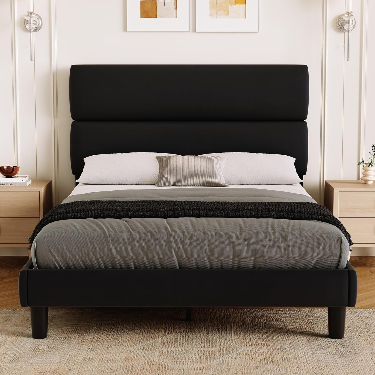 Closer bedroom view of a black platform bed with a tall split headboard and gray bedding.