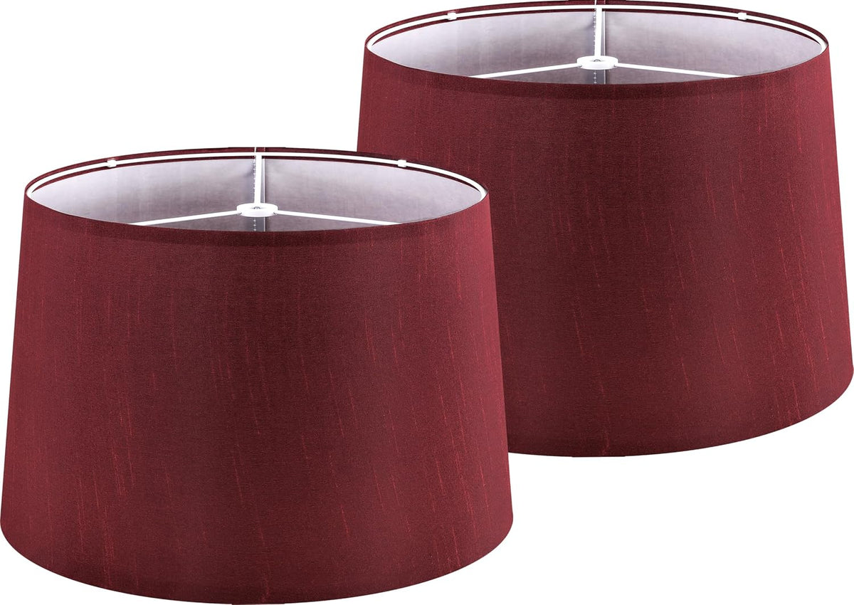 Two burgundy drum lampshades shown together, angled to show top spider fitter and fabric texture