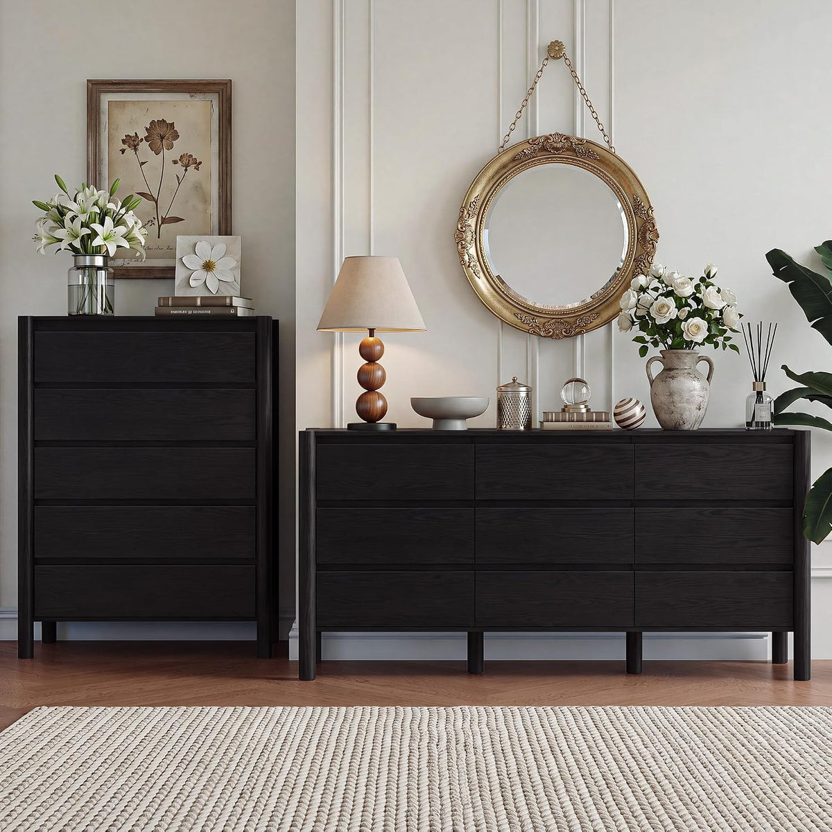 Matte black 2-piece dresser set staged under a gilded round mirror with table lamp and vase.