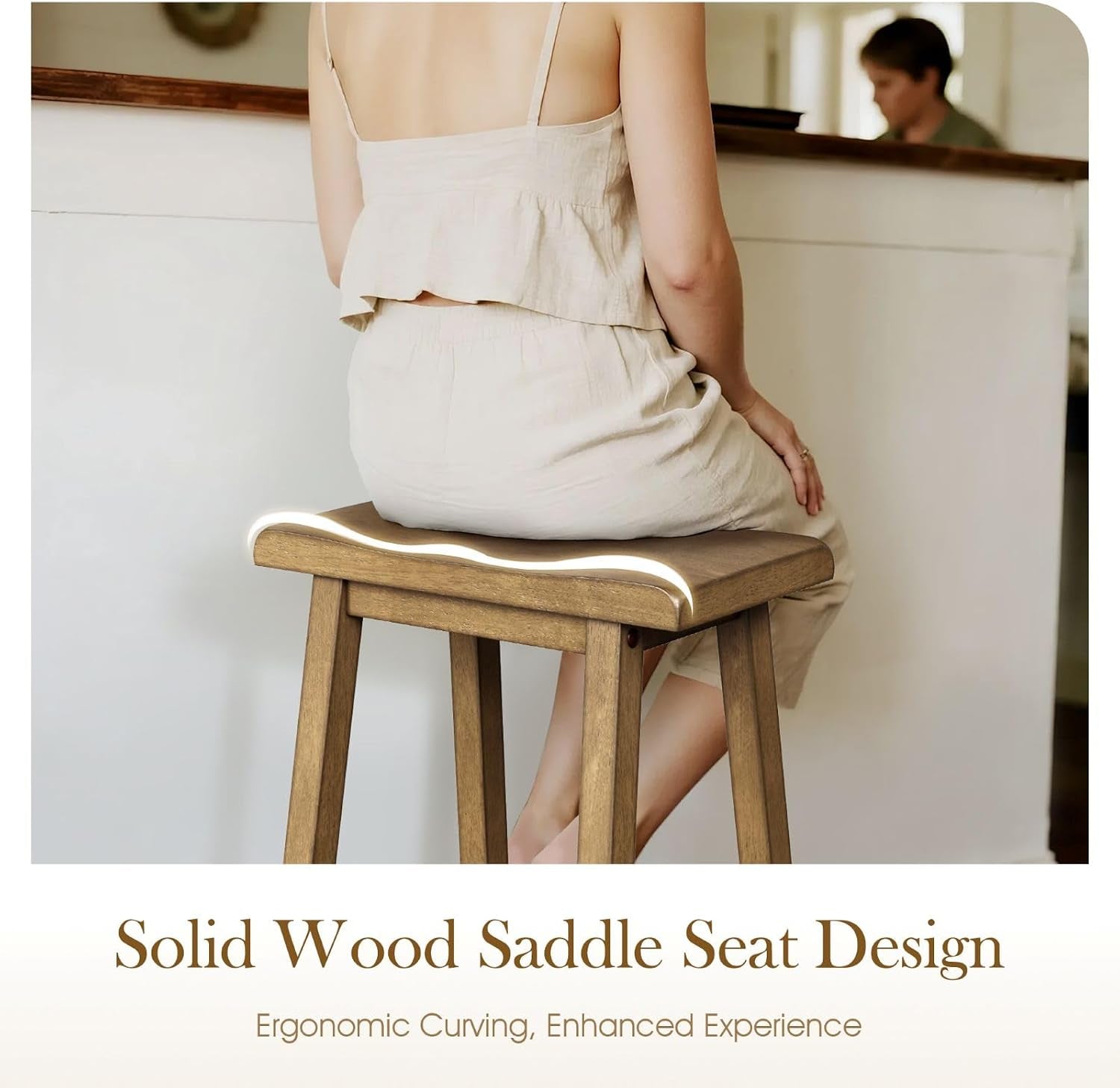 Seated person on a contoured saddle wood stool highlighting the ergonomic curved seat top