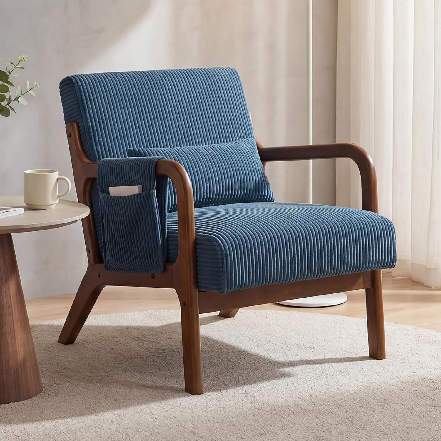 Close-up of one blue ribbed armchair showing curved wooden arms and a fabric side pocket.