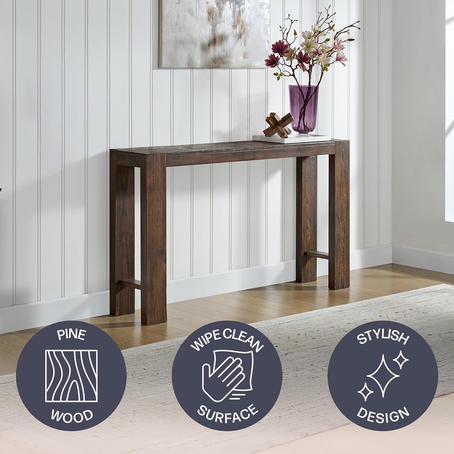 Brown solid pine narrow console table styled against paneled wall with icons for pine wood and wipe-clean surface