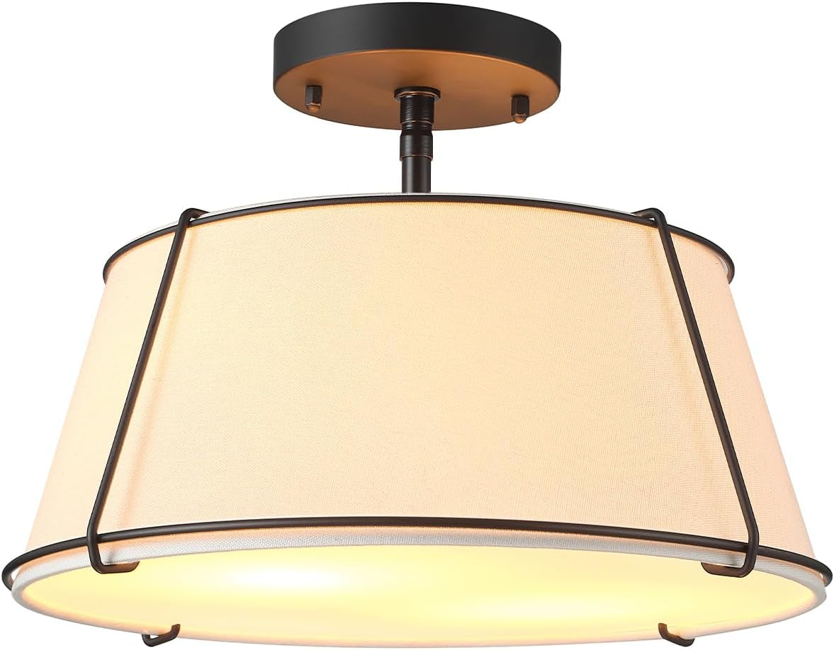 Angled view showing a tapered linen shade held by an external dark metal frame and round canopy.