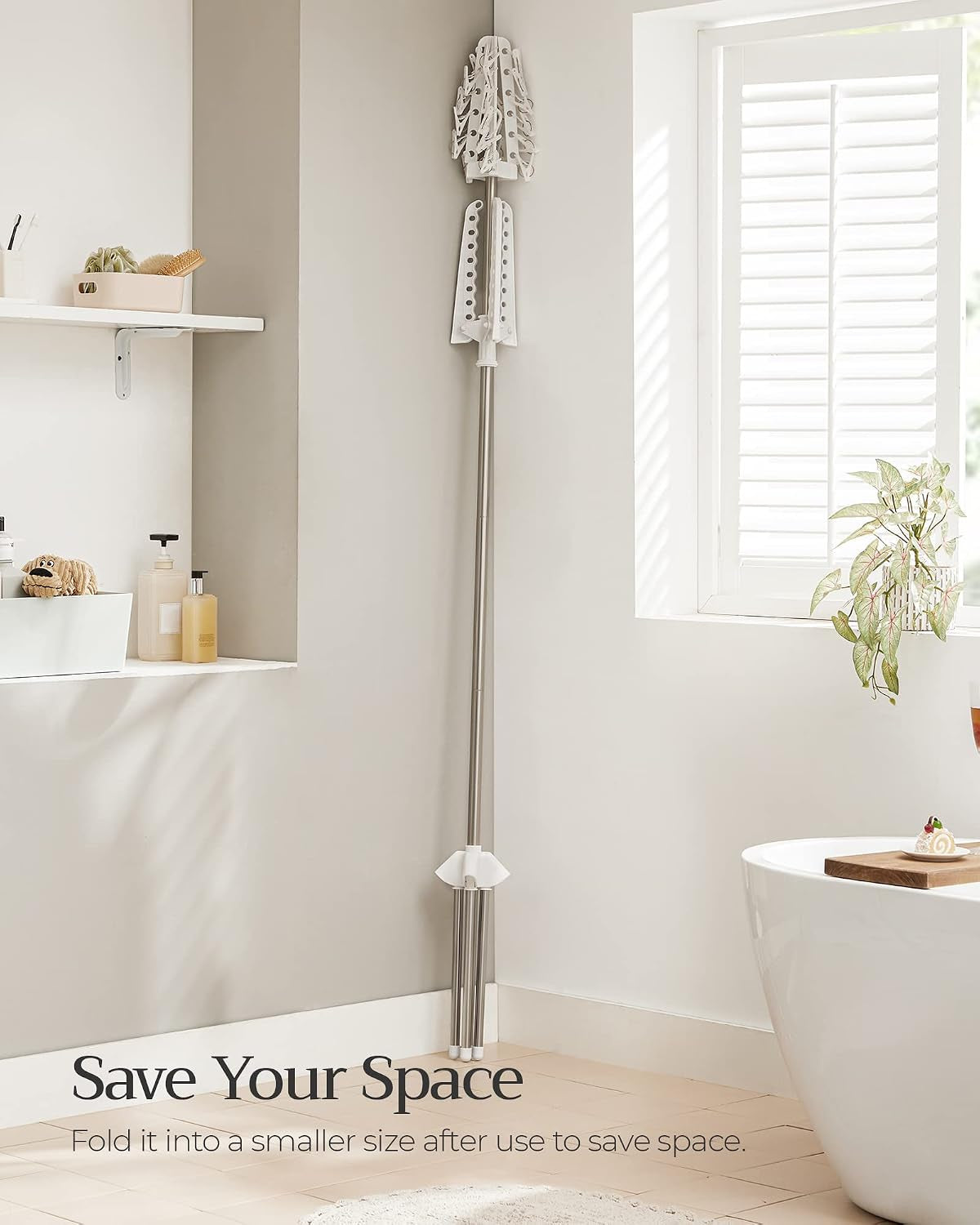 Folded clothes drying rack stored upright against a wall to show its compact folded size