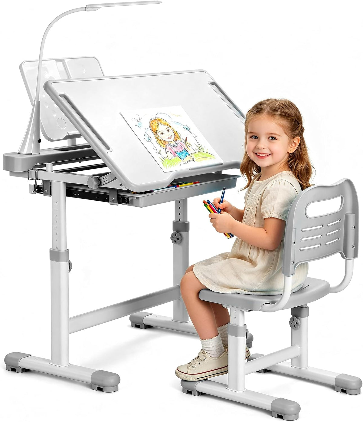 Young girl seated at an adjustable white-gray kids desk and matching chair, tilting desktop propped with a drawing and