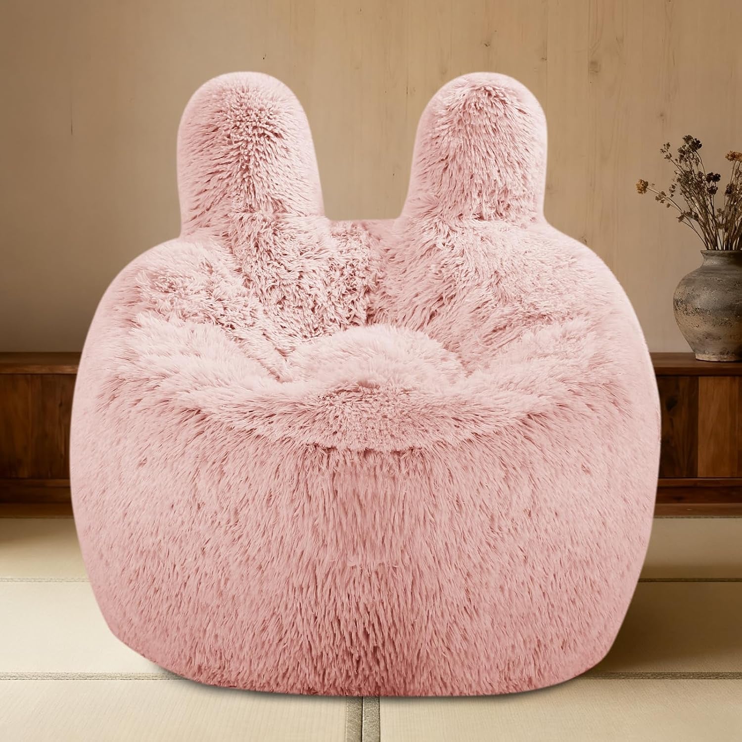 Front view of a pale pink fluffy bean bag chair with twin rounded back supports.