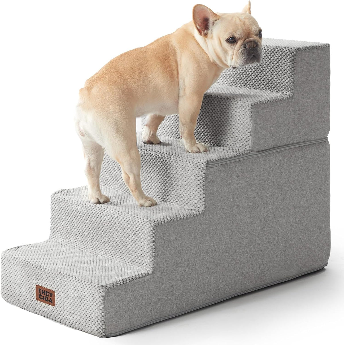 Side view of a light gray four-step pet stair with a small dog climbing the steps