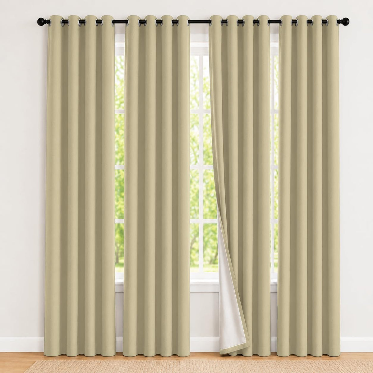 Wide view of a large window with two cream-beige blackout curtains, one panel slightly opened to expose white backing.
