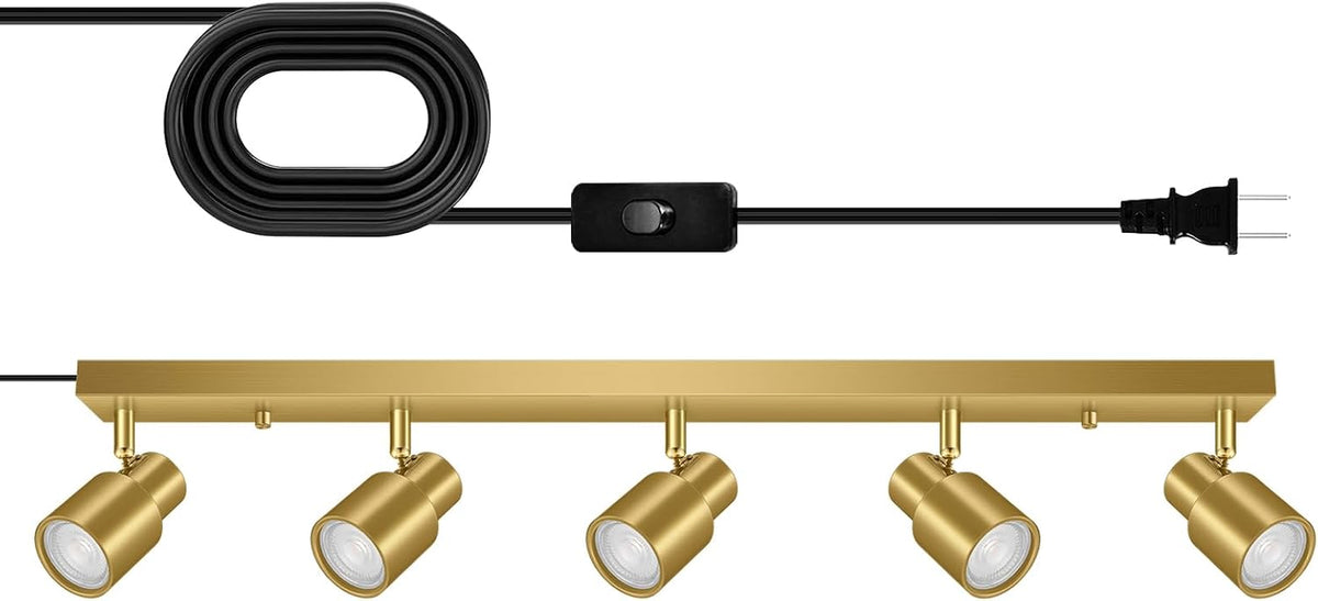 Brushed gold track bar with five adjustable gold spotlight heads and black coiled cord with inline switch
