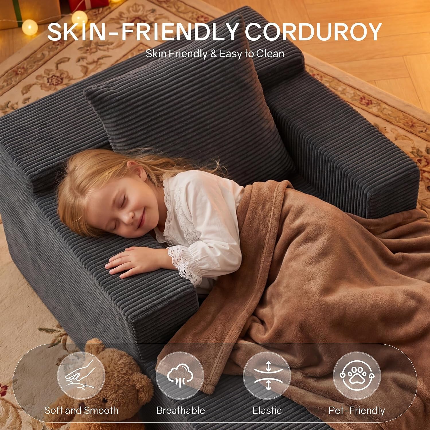 Top-down view of a child napping on the ribbed corduroy chaise, covered by a brown blanket showing fabric texture.