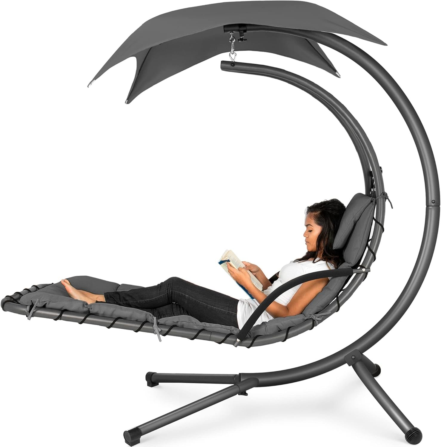 Grayscale side view of the curved hanging chaise showing shape and padding with a woman reclining.