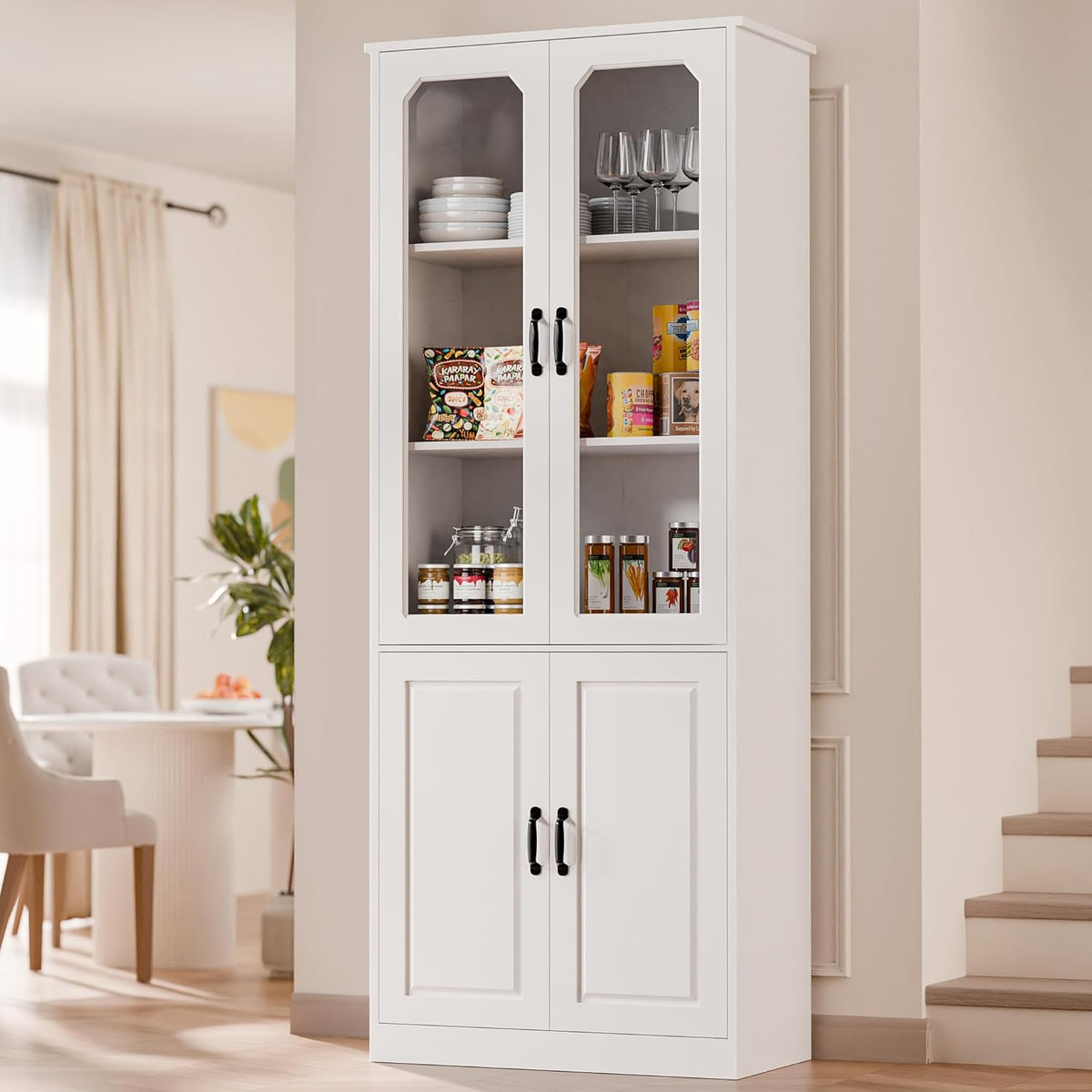 Tall narrow white pantry variant with two glass doors, stocked with dishes and pantry items in a hallway.