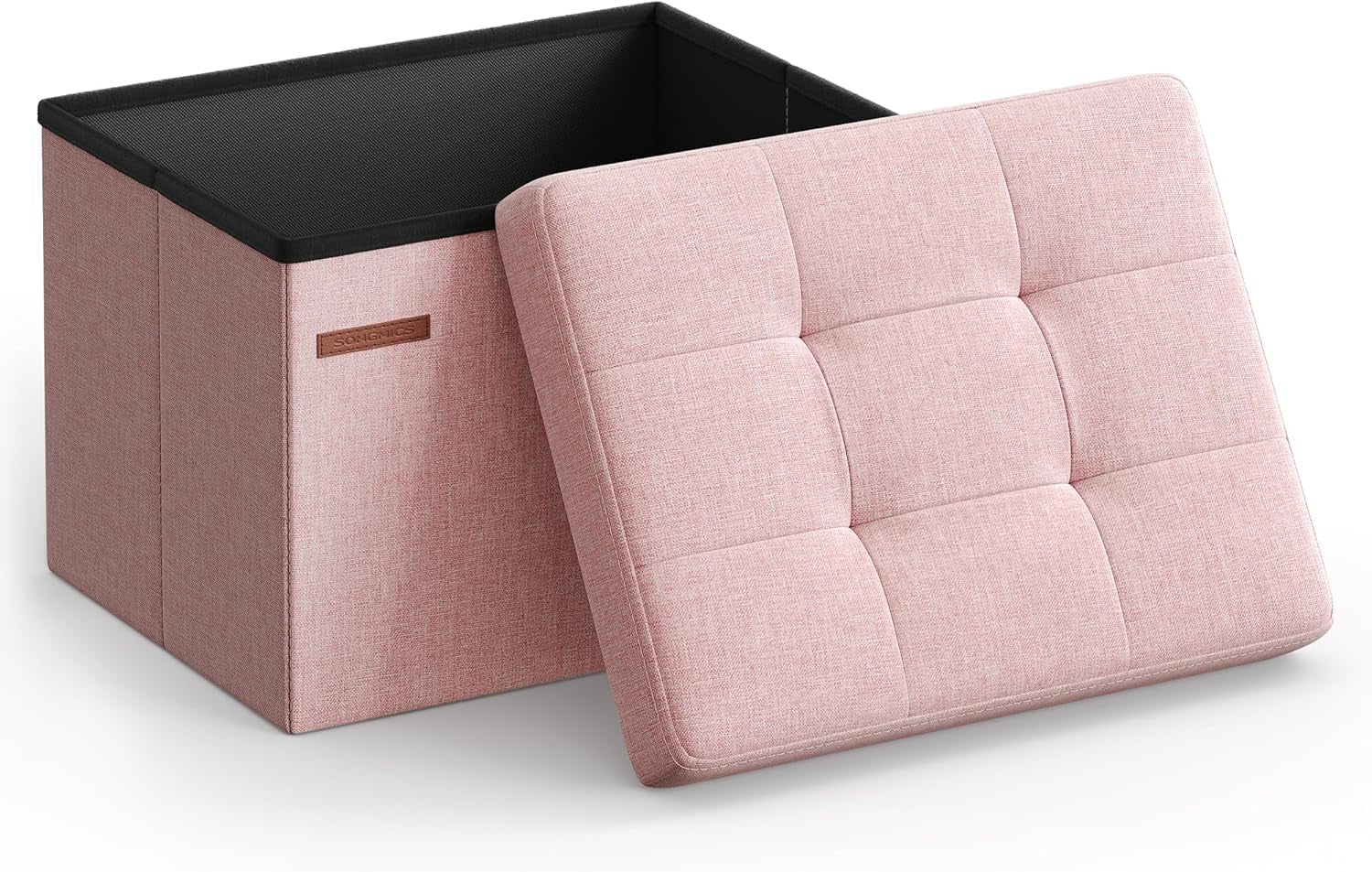 Open square folding storage ottoman with the tufted pink lid leaning against the box.