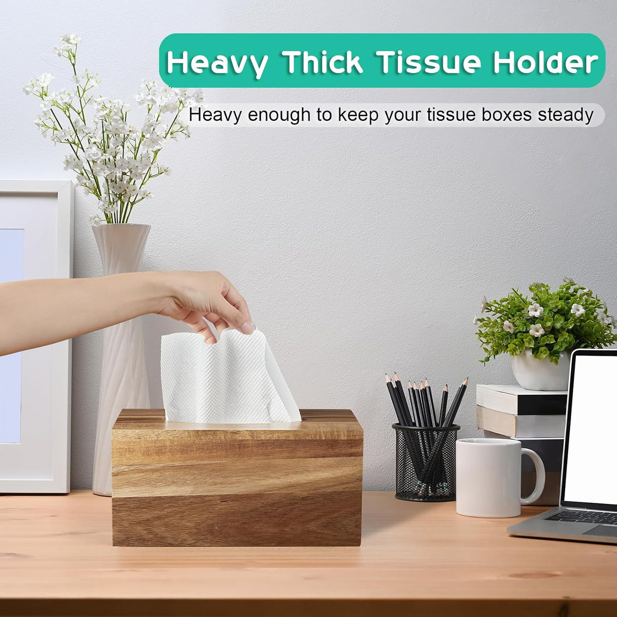 Rectangular tissue box cover on a desk with a hand pulling a tissue, pencils and laptop visible nearby