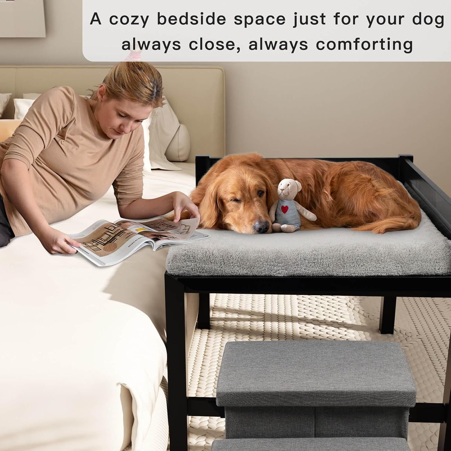 Woman lying on a mattress reading while a dog naps on the bedside pet bed with the three-step gray stairs in front.
