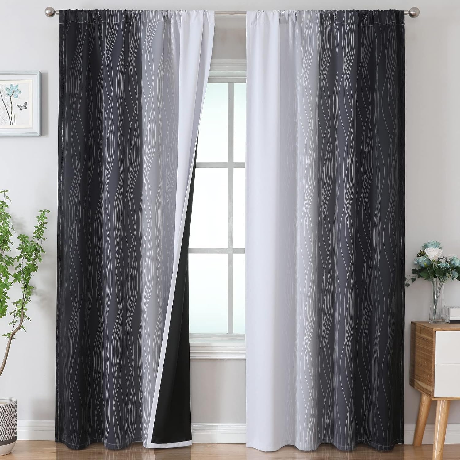 Window with two rod-pocket ombre curtains in dark gray to white with wavy line pattern, one panel slightly pulled back