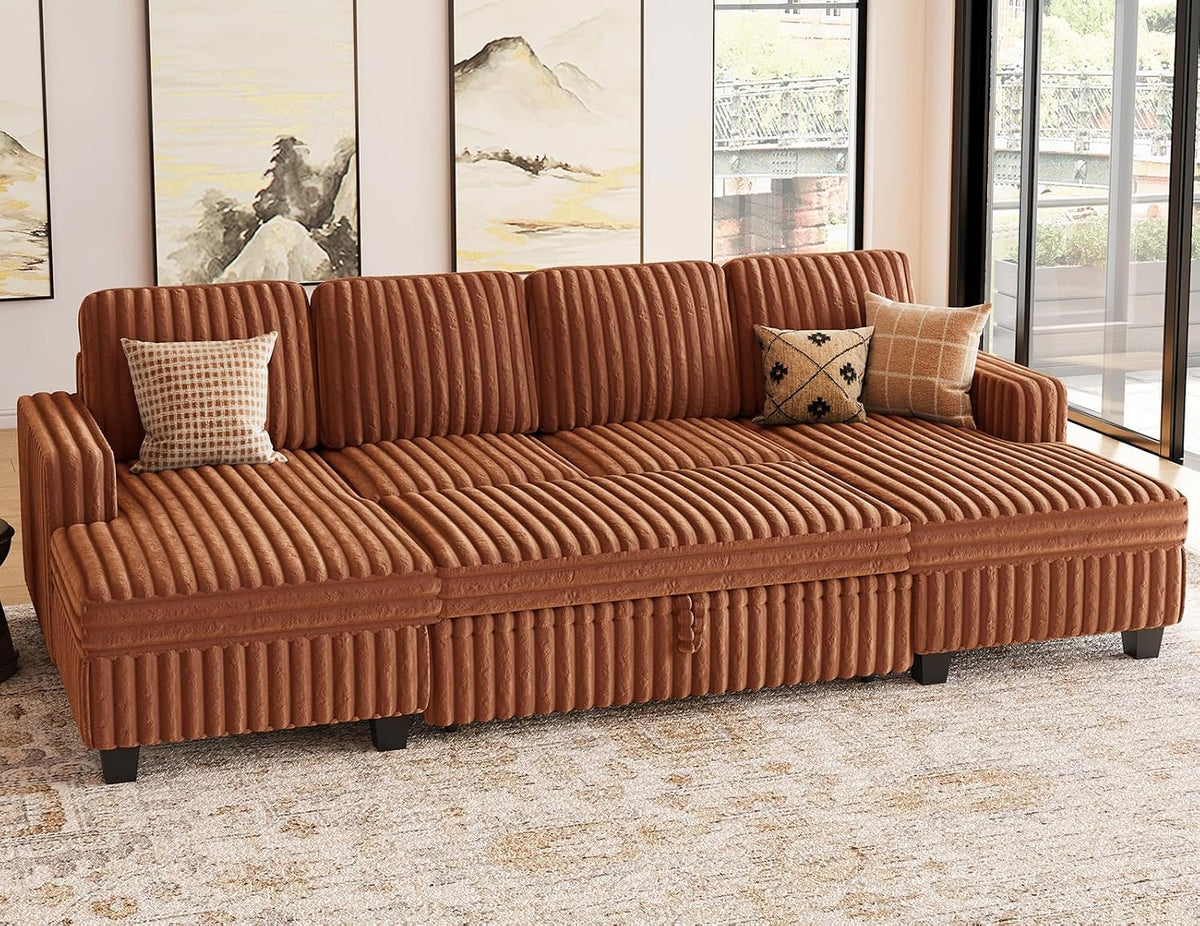 Rust-colored corduroy modular sofa with three cushions and two patterned throw pillows in a sunlit living room.