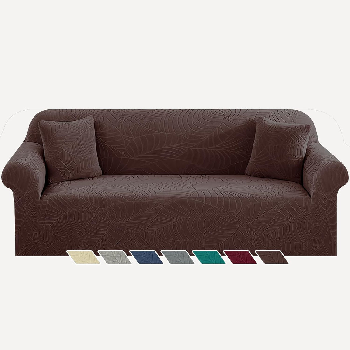 Low-angle view of a brown leaf-pattern slipcover on a three-seat sofa showing seat depth and a row of small color swatches
