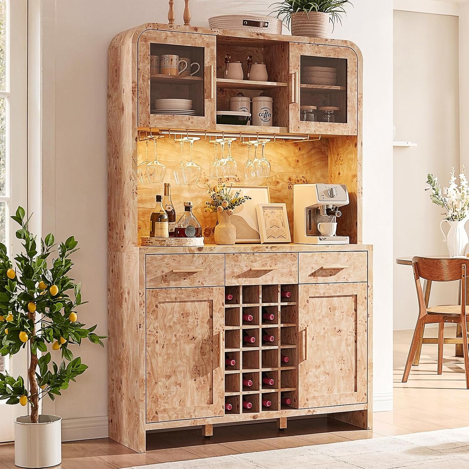 Burl-style buffet and hutch with warm backlighting, coffee maker on counter and potted lemon tree nearby