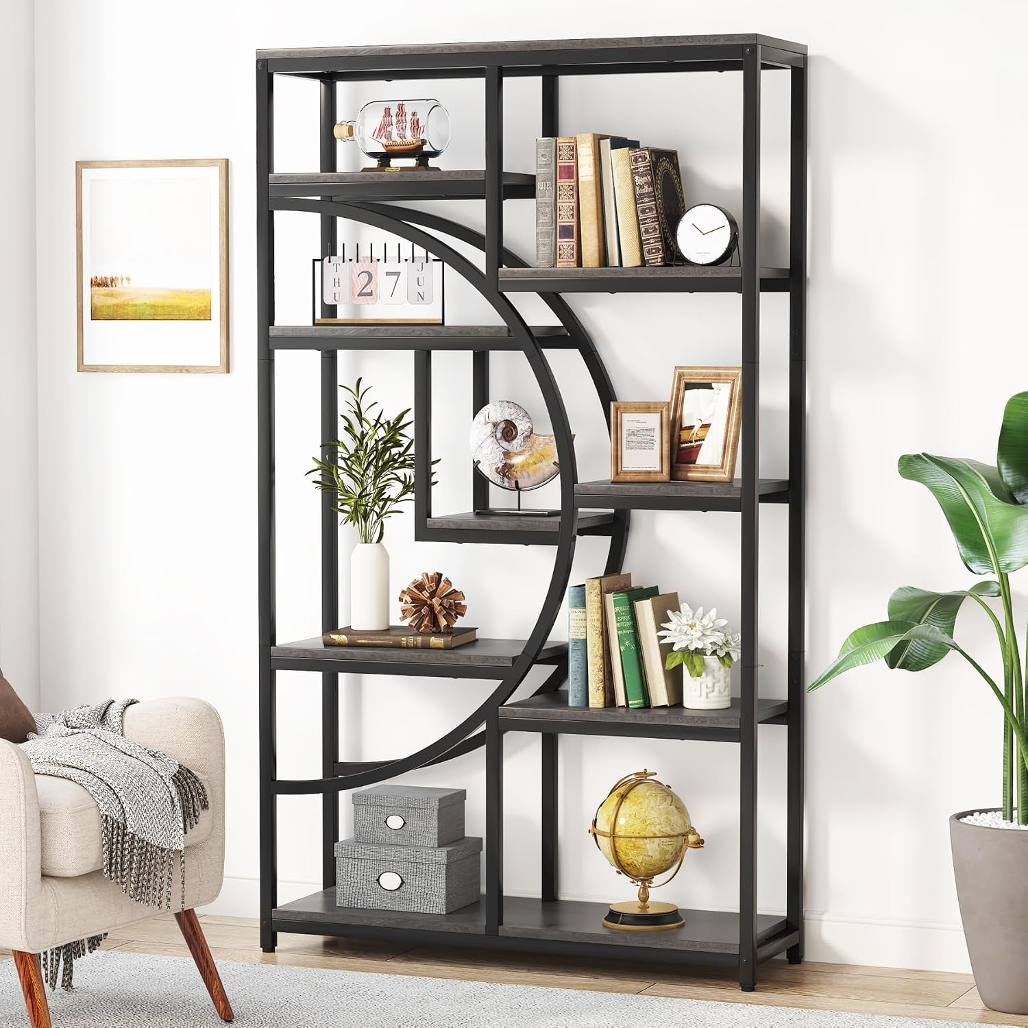 Black metal bookshelf with dark-stained shelves and bold curved supports, styled in a living area