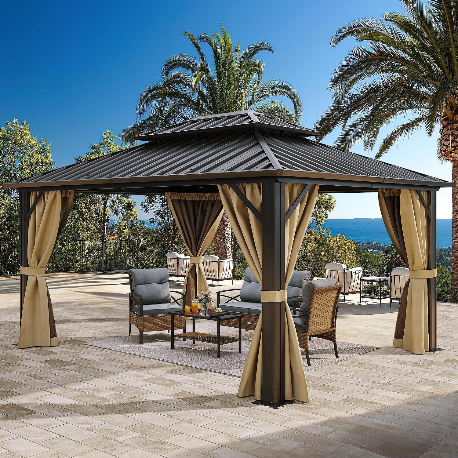 Front view of a metal-roof gazebo with tan drapes tied to corners, surrounding a cushioned seating group on a tiled patio